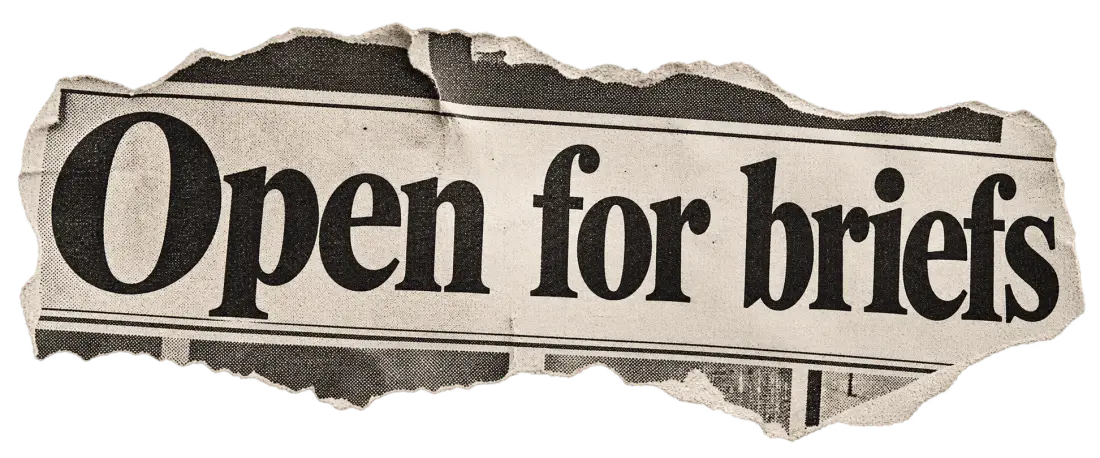 A torn newspaper headline that reads: Open for briefs.